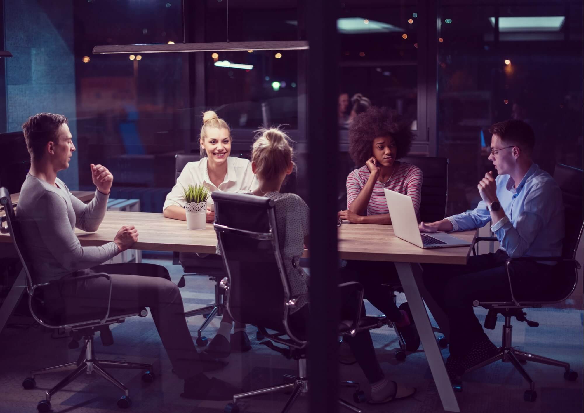 Group of people in a business meeting around a table.