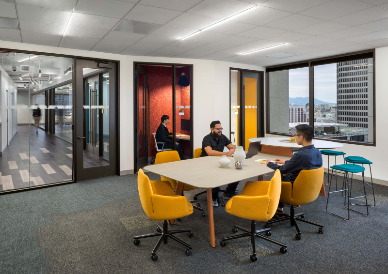 Modern office with meeting area and private booths.
