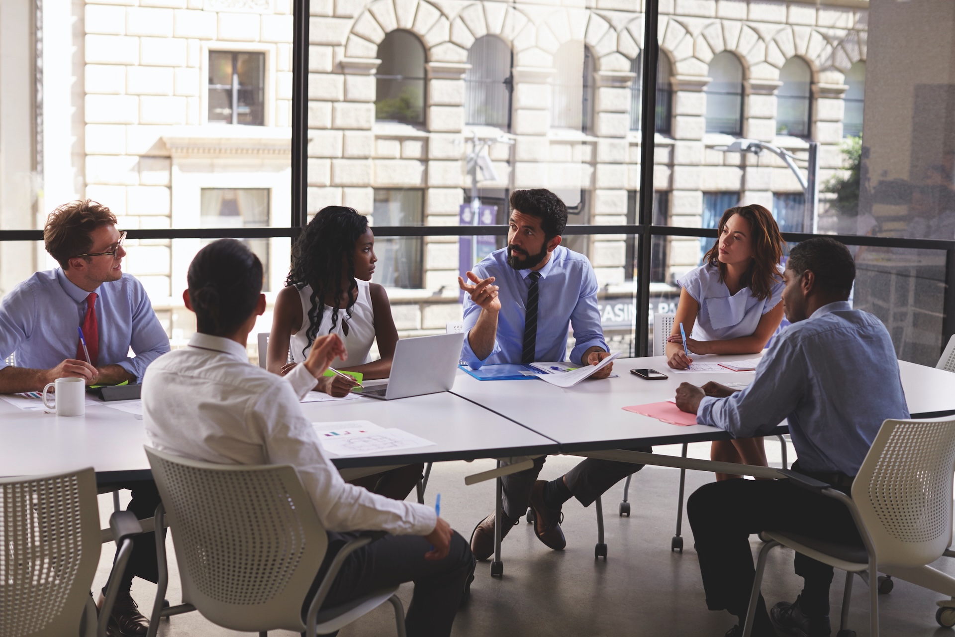 People around table in a meeting room.
