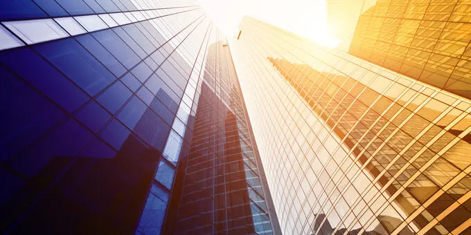 Low angle of city skyscrapers, sunny day.