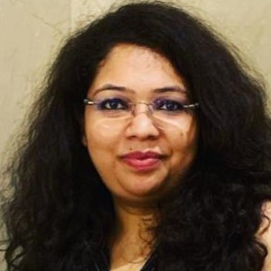 Portrait of a woman wearing glasses with black hair.