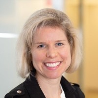 Portrait of Meg Gannon smiling with blonde hair.