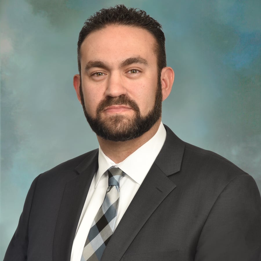 Portrait of a man wearing a suit and tie.