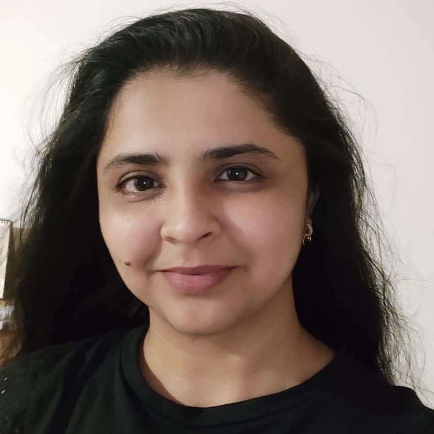 Woman with long black hair, wearing black top.